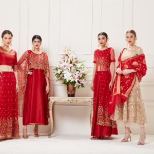 Four women showcasing luxurious Indian lehengas in a studio setting. Perfect blend of traditional elegance and modern style.