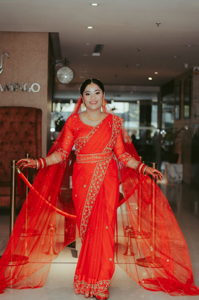 Beautiful Indian bride in a vibrant red saree, showcasing elegance and tradition.