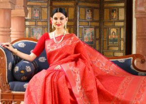 Elegant Indian woman in traditional saree sitting gracefully indoors, capturing cultural heritage.